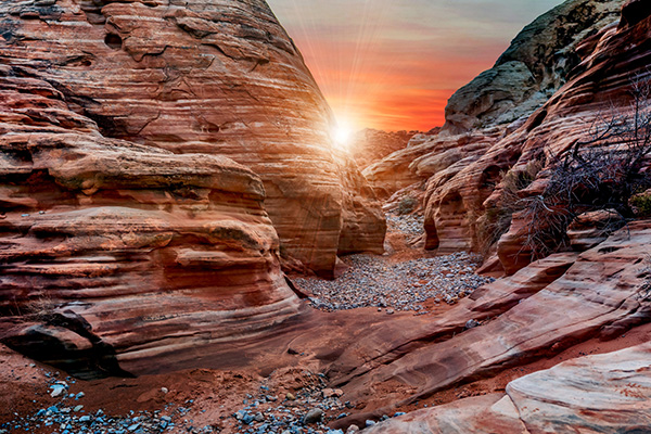 Breathtaking canyon view at sunset with warm glow and towering rock formations.