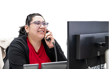 woman on taking a phone call at work at her desk