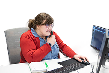 woman on taking a phone call at work at her desk