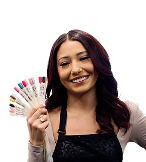 nail technician student smiling and holding up different colored artificial nails