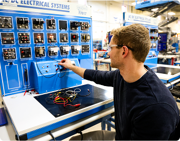 about-us-mission-statement - Ogden Weber Technical College student adjusting large electrical equipment during class