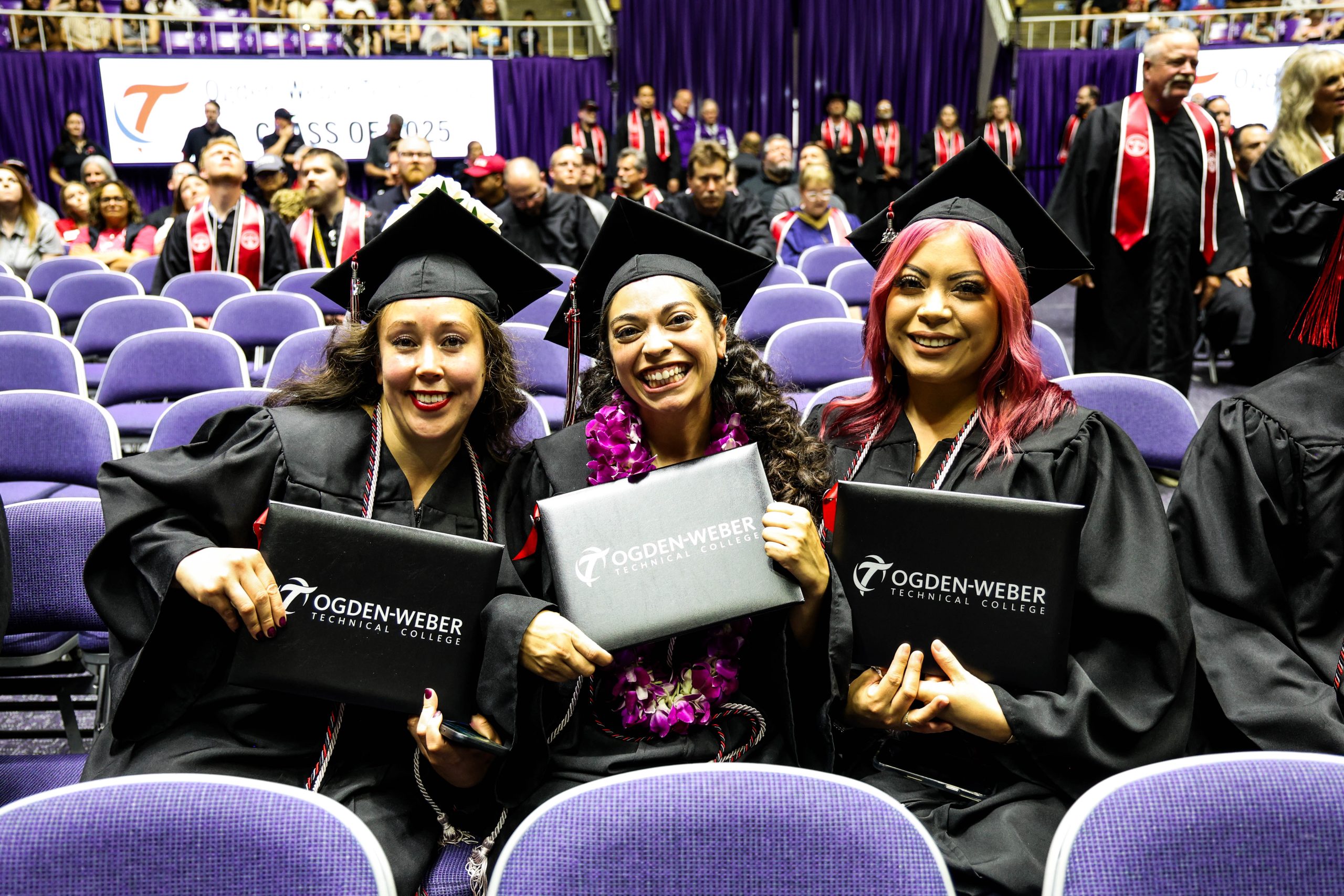 information-tech-hero-video - Ogden Weber Technical College three graduates at ogden-weber technical college pose for a picture, holding their diplomas