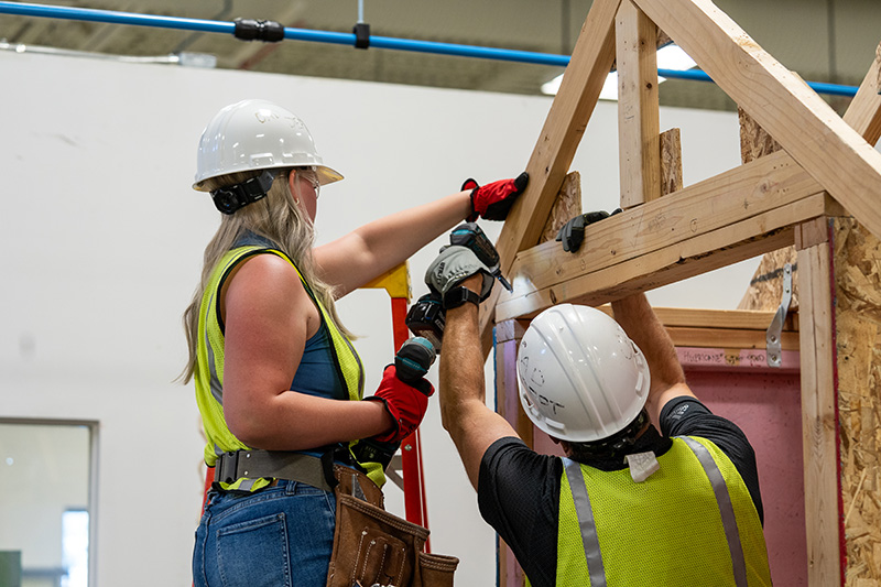 students learning and building structures in the carpentry program