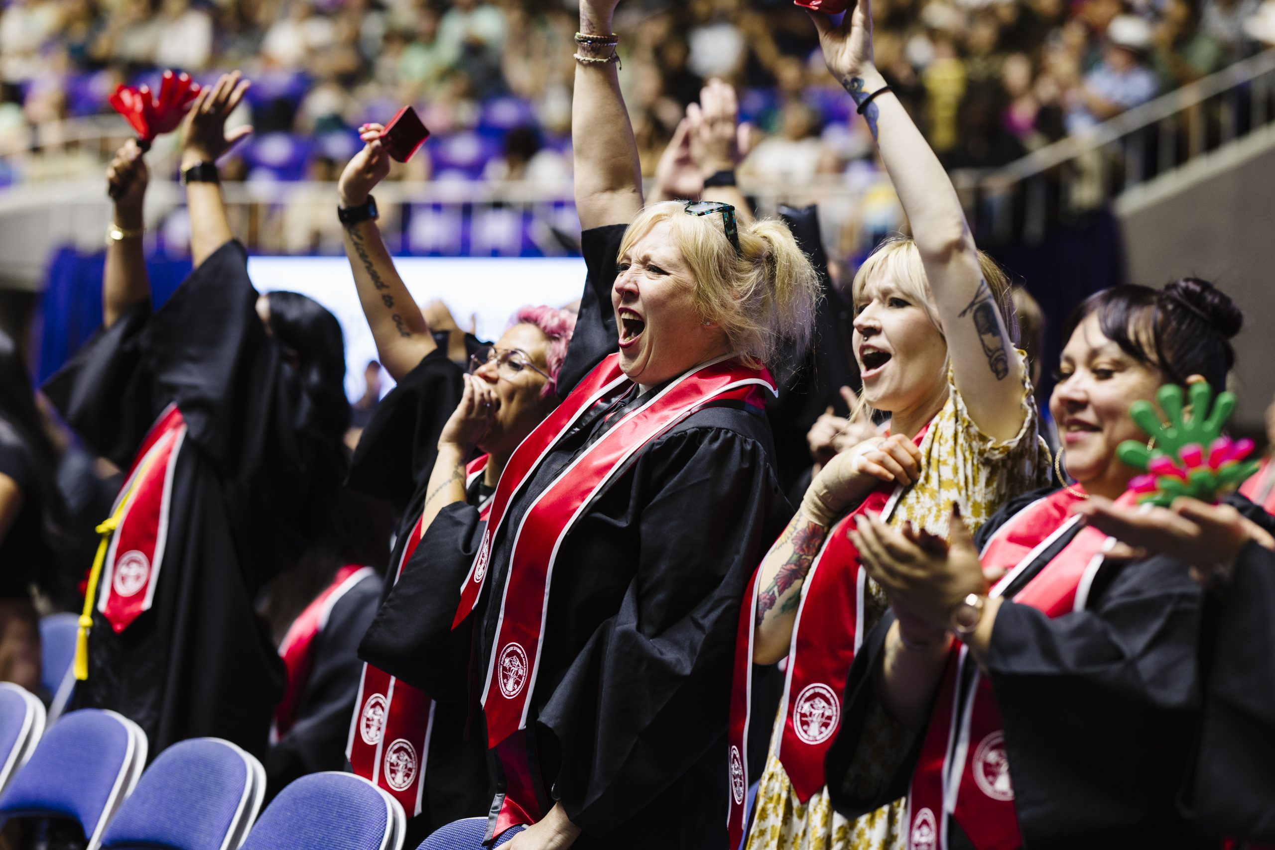 Instructors of Ogden-Weber Technical College cheering as students graduate