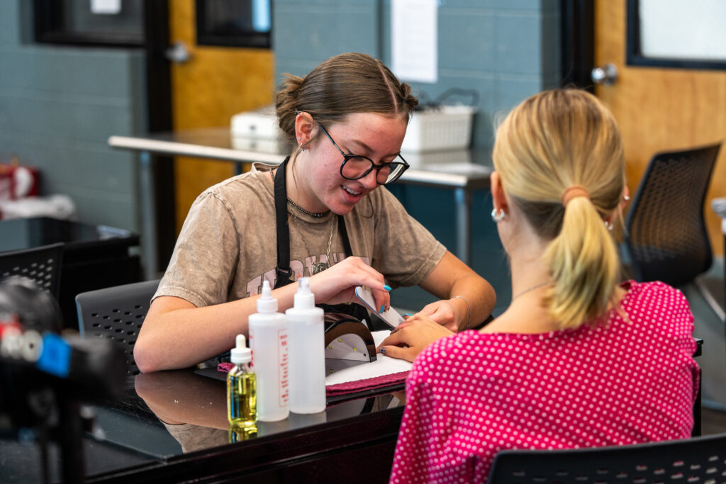 a student doing a clients nails
