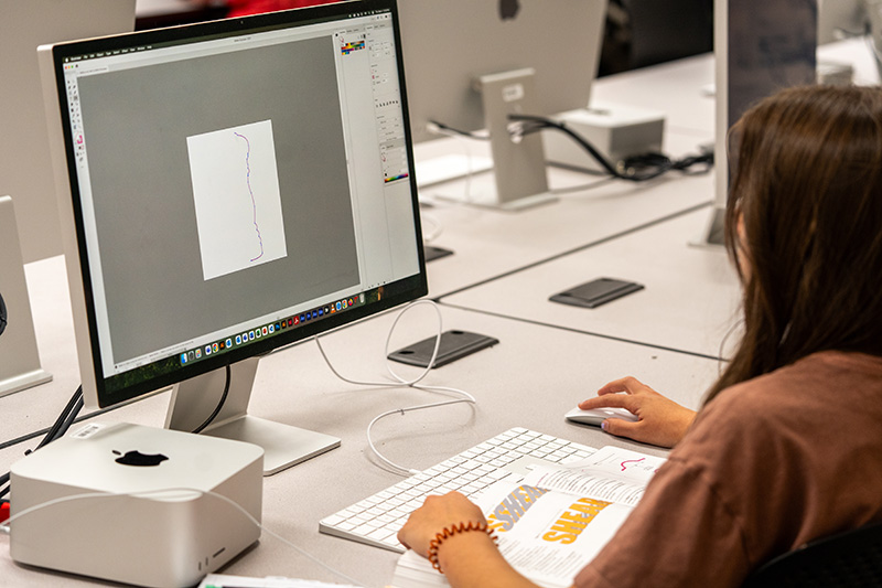 a student starting a design at a computer