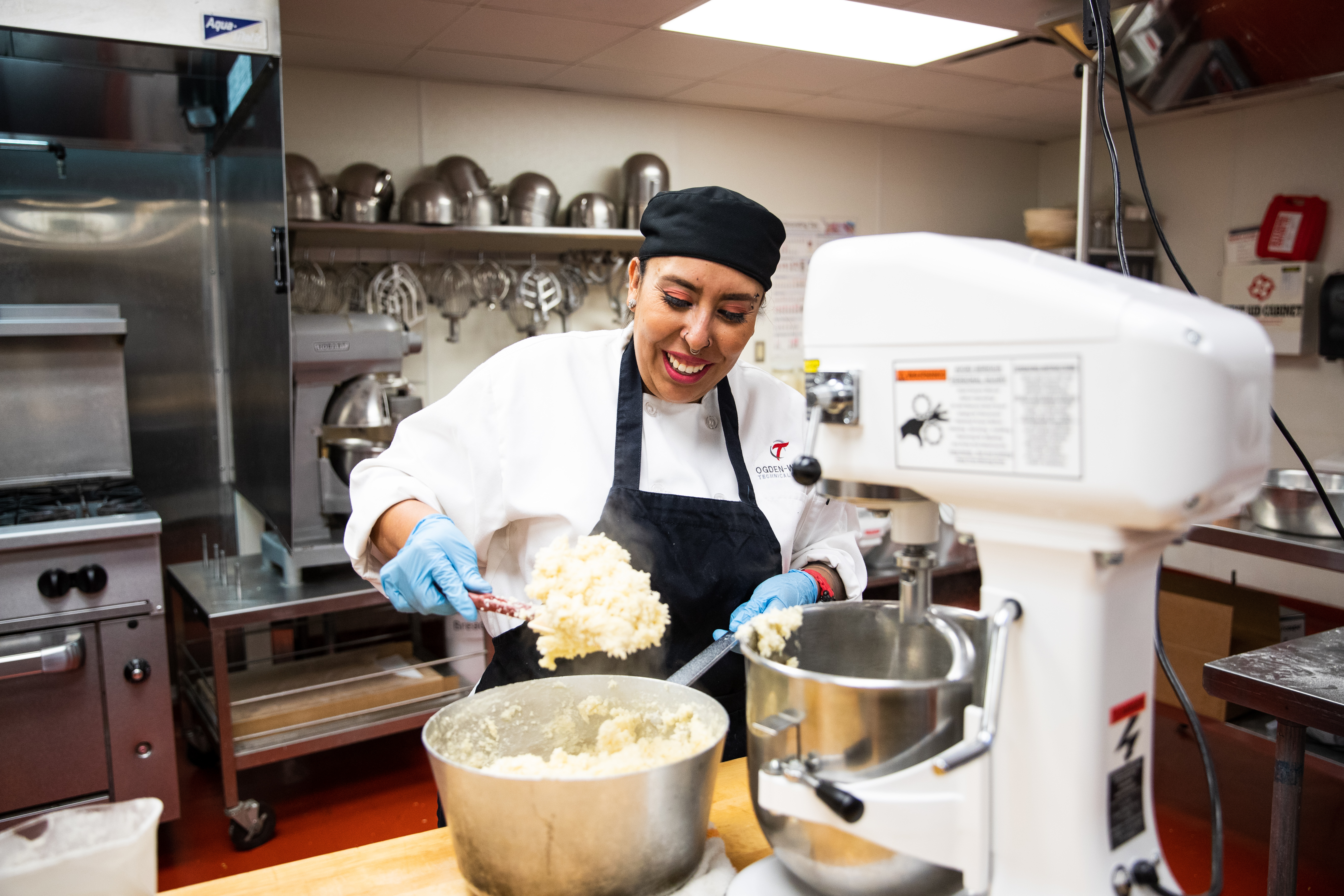 student in the culinary program preparing some food and learning