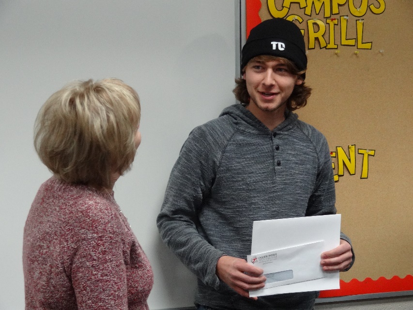 - Ogden Weber Technical College Jan Burton, Financial Aid manager, and Caleb Mecham, award recipient.