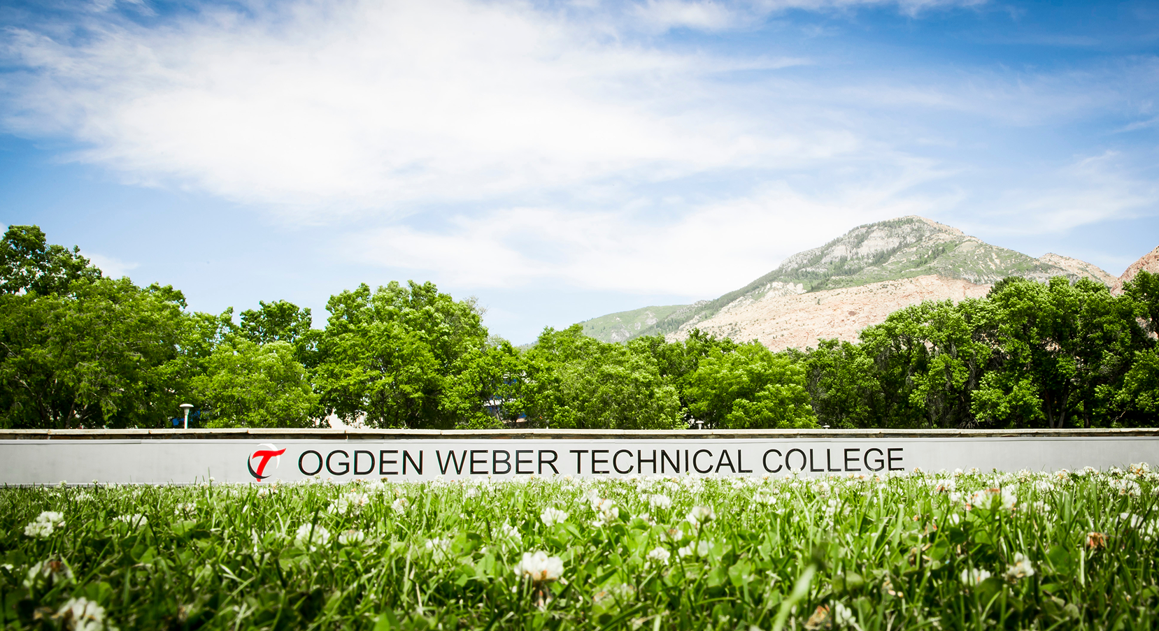 Ogden Weber Technical College entrance sign with mountains and blue sky in the background