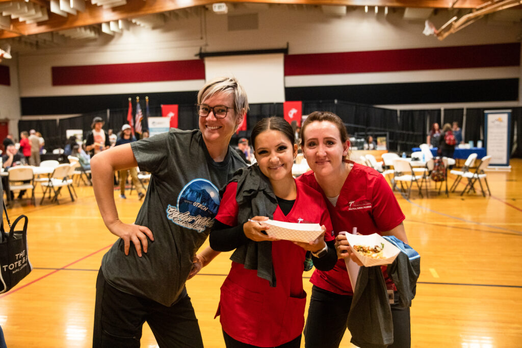 Students and an instructor pose for a photo at an OTECH event.